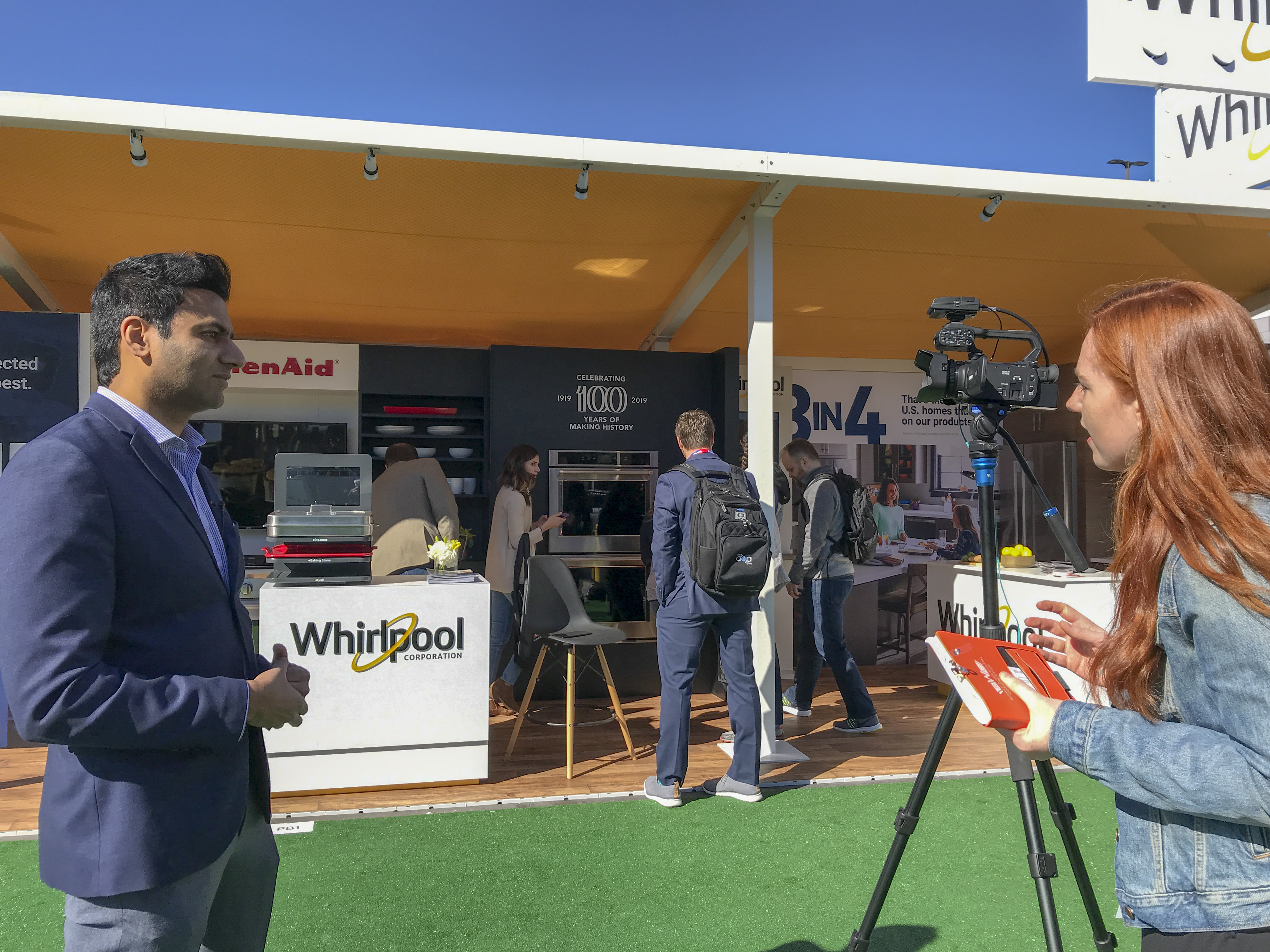 Whirlpool Corporation representative Jason Mathew participates in a media interview during a trade show.