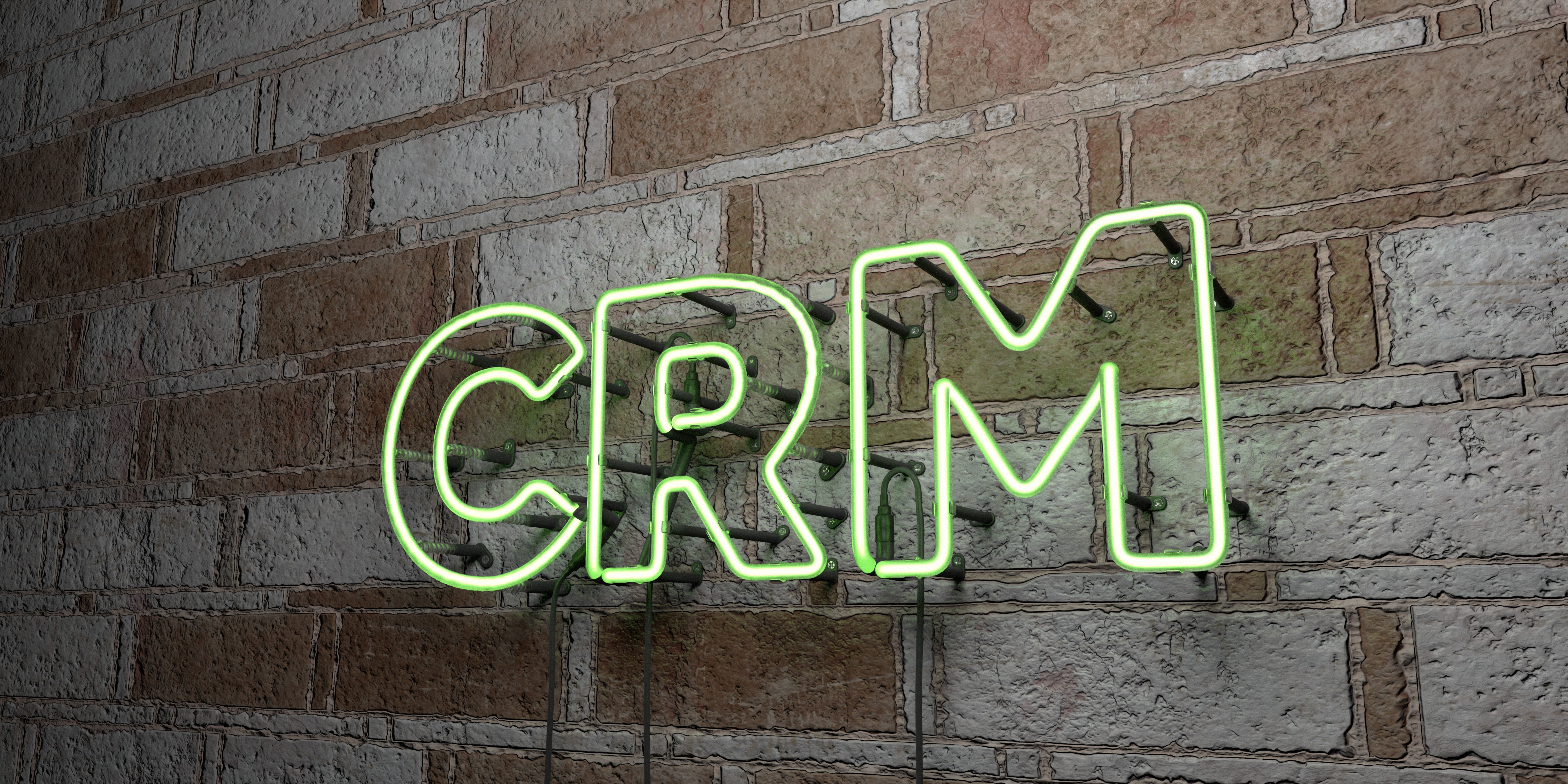A glowing neon sign that reads "CRM," which stands for customer relationship management.